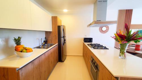 a kitchen with a bowl of fruit on the counter at Amar'e Aparthotel & Spa in Las Terrenas