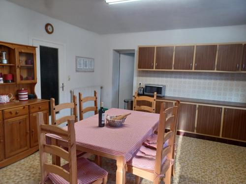 a kitchen with a table and chairs in a room at 9 Guests - Pet Friendly in rural West France in Clussais-la-Pommeraie