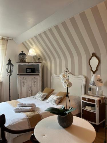 ein Schlafzimmer mit einem weißen Bett und einem Tisch in der Unterkunft VILLA NOTRE DAME face au Château fort in Sedan