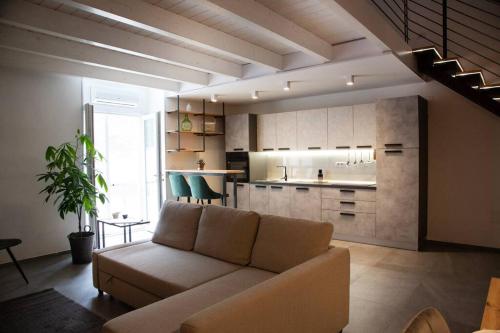 a living room with a couch and a kitchen at 24 Maggio Apartment in Galatina