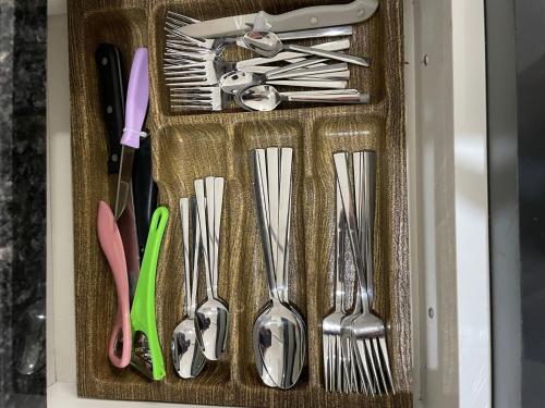 a drawer with forks and spoons and utensils at Modern Comfort In Atasehir in Istanbul