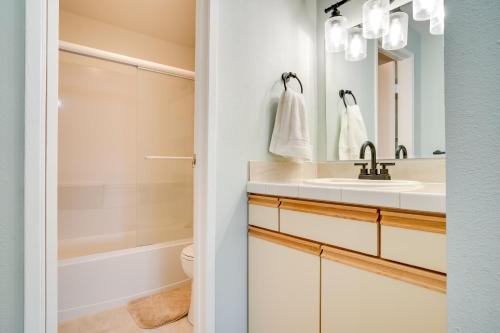 a bathroom with a sink and a toilet and a mirror at Lovely Crescent Bar Condo with Community Amenities! in Quincy