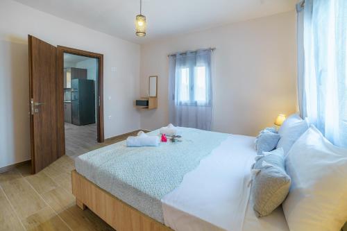 a bedroom with a large bed and a mirror at Rose View in Ierápetra