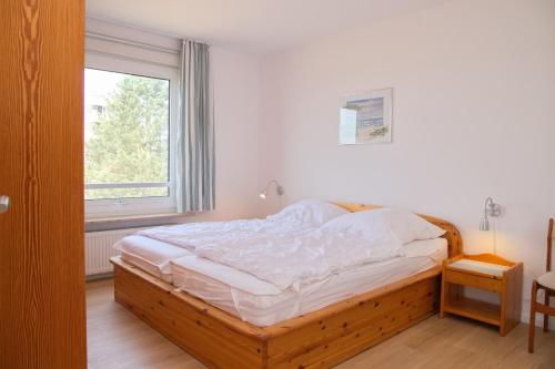 Schlafzimmer mit einem großen Bett und einem Fenster in der Unterkunft Hanseat II App 148 in Grömitz