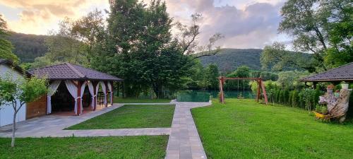 a garden with a gazebo and a playground at Villa Sara on river Una in Bihać