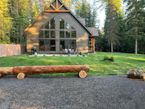 a log on the ground in front of a house at Glacier Homestead in Coram