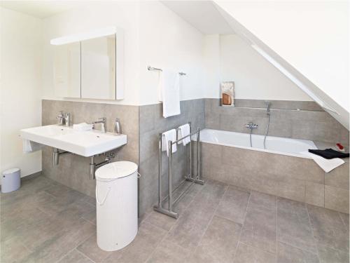 a bathroom with a sink and a bath tub at Exklusive 5,5 Zimmer Wohnung für Familien und Business in Eschenz