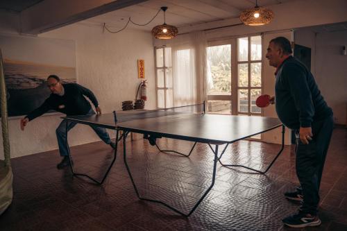 two men playing ping pong on a ping pong table at Hotel Palma de Mallorca in La Paloma