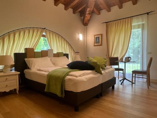 a bedroom with a large bed in a room at Steba House Savani Barbara Foresteria Lombarda in Lonato