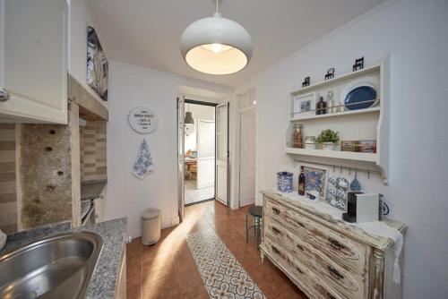 a kitchen with a sink and a counter top at Lx Factory Apartment! Outside terrace in Lisbon