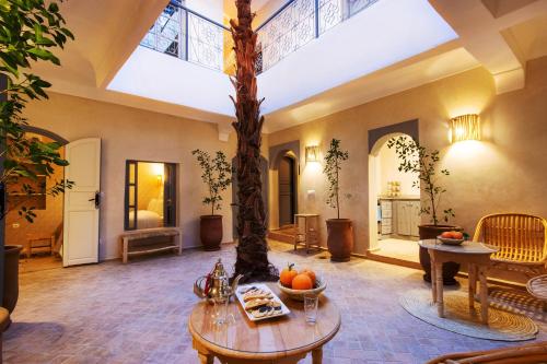 a large living room with a tree in the middle at Riad Berrima - Breakfast - 10mn from Jamaa Al Fna in Marrakech