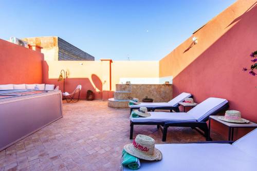 a patio with two chairs and a table at Riad Berrima - Breakfast - 10mn from Jamaa Al Fna in Marrakech