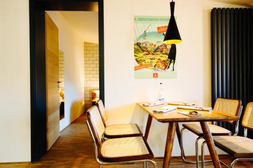 a dining room with a wooden table and chairs at Apartmenthotel Oberstdorf in Oberstdorf