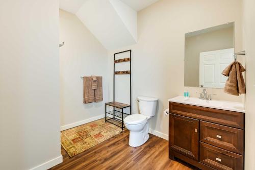 a bathroom with a toilet and a sink at Waterfront Kenai Townhome Less Than 1 Mi to Beach! in Kenai