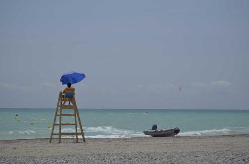 a life guard tower and a boat on a beach at Chalet en playa de Almardá in Almarda