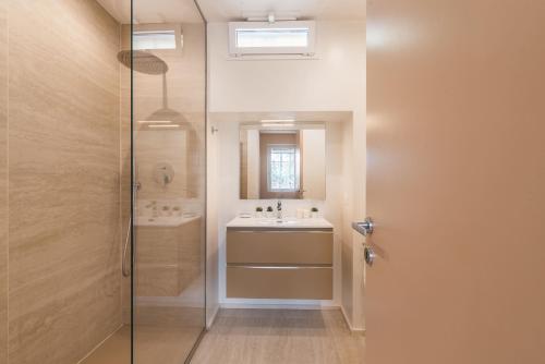 a bathroom with a glass shower and a sink at The Best Rent - Spacious apartment with terraces with panoramic view of Rome in Rome