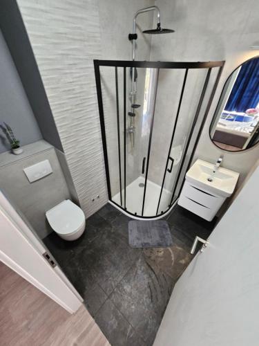 a bathroom with a shower and a toilet and a sink at Villa Karla in Jadranovo