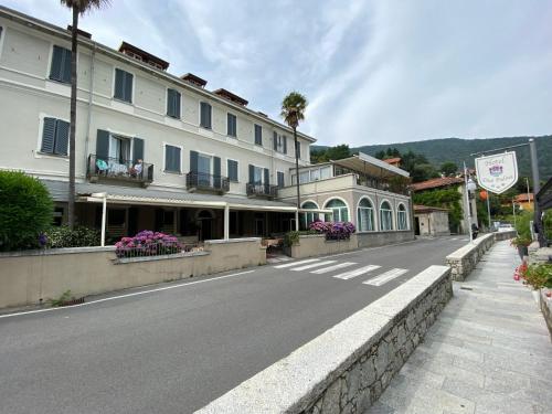 an empty street in a town with a building at Hotel Due Palme in Mergozzo