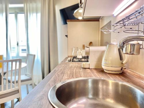 a kitchen counter with a sink and a mixer at CasaViva - Le Vele di Angela in Genoa