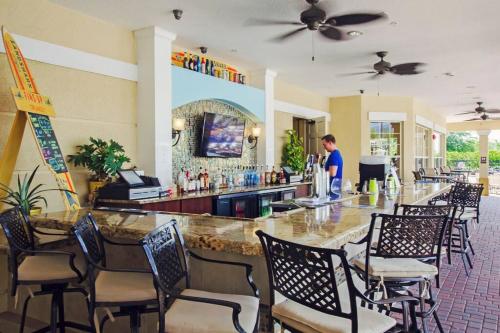 a man standing at a bar in a restaurant at Luxury Lake View Condo-Vista Cay in Orlando