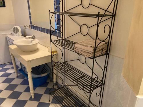 a bathroom with a towel rack next to a sink at Chez mamie Nénette in Barrême