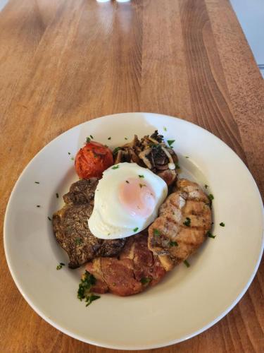 a white plate with an egg on top of food at Garth Hotel in Grantown on Spey