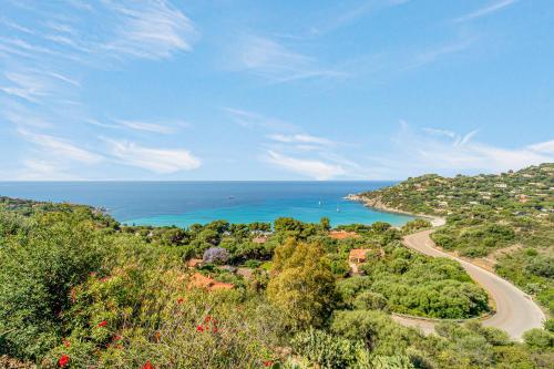 a view of a road and the ocean at Sardinia Villa Torre delle Stelle in Torre delle Stelle