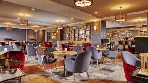 a restaurant with tables and chairs and a bar at Mespil Hotel in Dublin