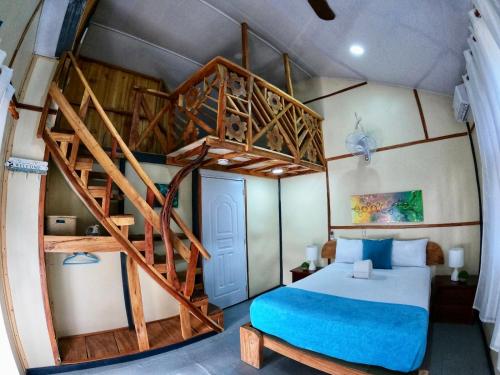 a bedroom with a bunk bed and a spiral staircase at Rustic House Punta Rucia in Punta Rucia