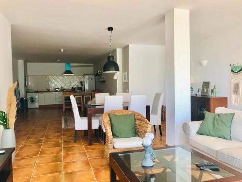 a living room and kitchen with a table and chairs at La Perla de Frigiliana Suites & Villa in Frigiliana