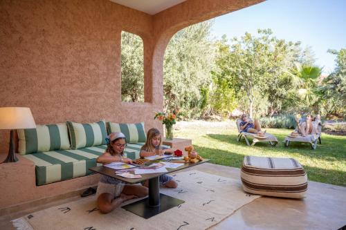 two women sitting at a table in a living room at Oasis lodges in Marrakech