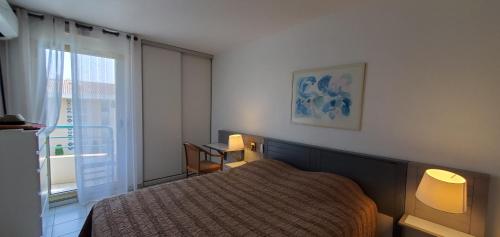 une chambre avec un lit et une fenêtre dans l'établissement OPEN, T2 42m2, 4 personnes, clim, balcon, piscine, à Fréjus