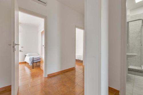a hallway with white walls and a tile floor at Villa delle Mimose by BarbarHouse in San Foca