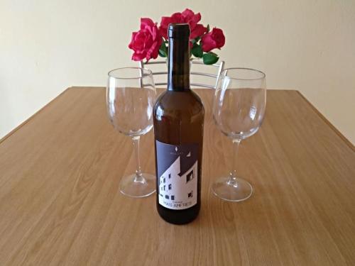 a bottle of wine and two wine glasses on a table at Apartamento 1ª línea de playa!!! in Cambrils