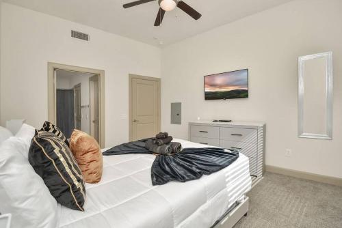 a bedroom with a white bed with a teddy bear on it at Stars In The Moon Fully Furnished in Houston