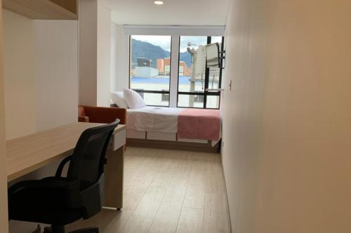 Postel nebo postele na pokoji v ubytování Apartahotel Connect Bogotá
