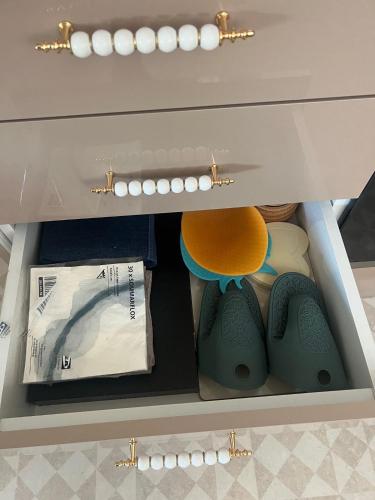 a drawer in a cabinet with some items in it at Hill's View in Barnstaple