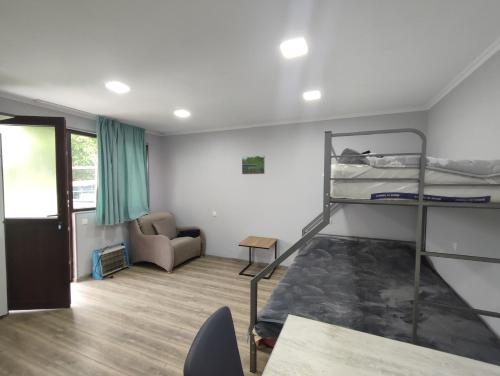a room with two bunk beds and a couch at Ananuri Cottages in Ananuri