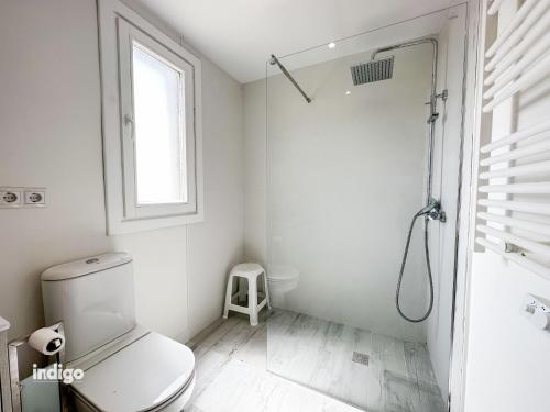 a white bathroom with a shower and a toilet at Bright Refurbished 3 Bedroom Townhouse ALI001 in Ayamonte