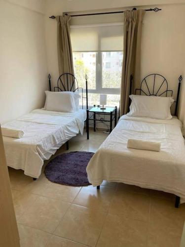 a bedroom with two beds and a window at Caesar resort & SPA, Claudius 2 bedroom apartment, Iskele, Long beach in Saint Yeorgios