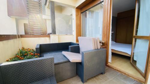 a room with a balcony with a bed and a mirror at Apartamento Playa de Barro in Barro de Llanes
