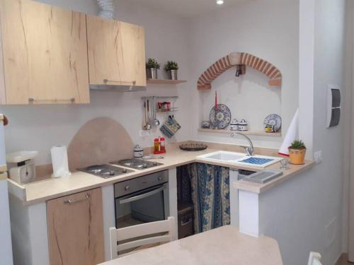 a kitchen with a sink and a stove top oven at Costa del Sole 46 in Cetona