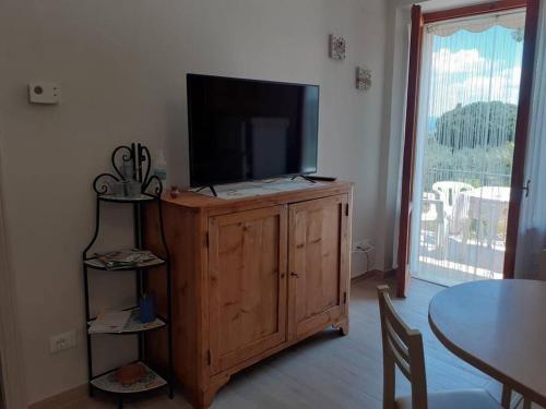 a television on a wooden cabinet in a living room at Costa del Sole 46 in Cetona
