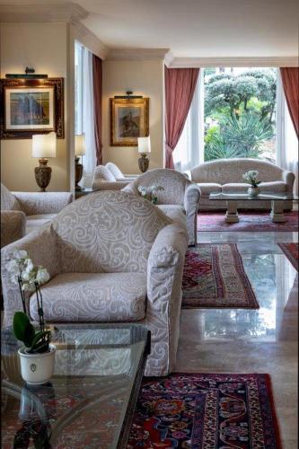 a living room with a couch and a table at Hotel Greif in Lignano Sabbiadoro