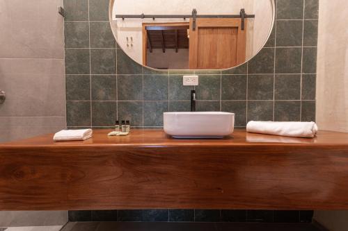 a bathroom with a wooden counter with a mirror at Soy Local Insignia in Cartagena de Indias