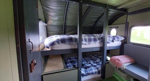 a bedroom with bunk beds in an rv at Little Middop Farm Camping Pods in Gisburn
