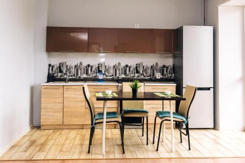 a kitchen with a table and chairs in a room at Уютная и комфортная 3х комнатная квартира со всеми условиями in Uralsk