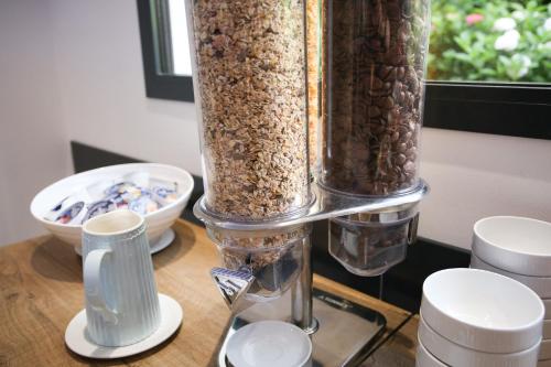 a table with three tall glass containers of food at Hotel Bellavista Locarno in Locarno
