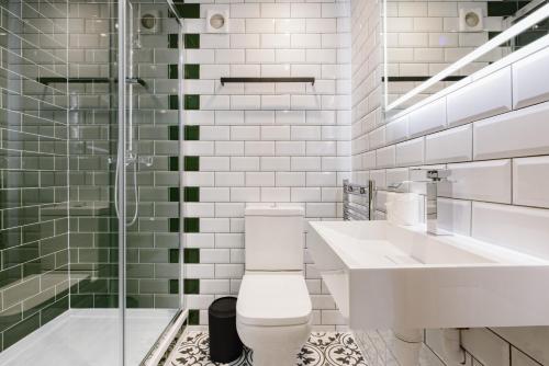 a bathroom with a toilet and a sink and a shower at CitySpace Kings Cross in London