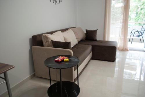 a living room with a couch and a table at Mina's Spacious Studio Apt : June '23 Renovated in Thessaloniki
